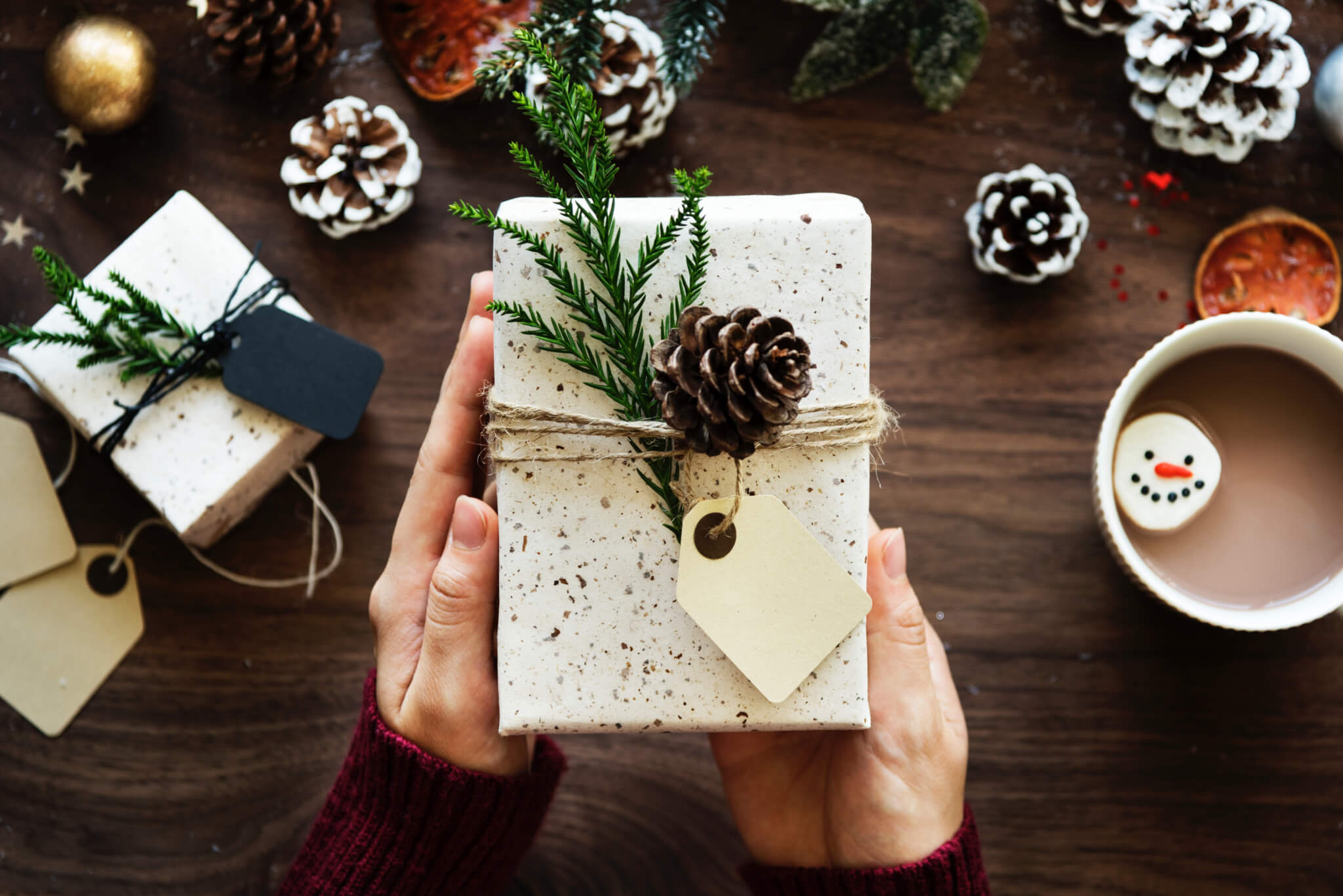 hands holding a rustic Christmas box